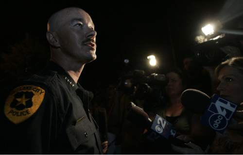 |  Tribune File Photo

Police Chief Chris Burbank answers questions from the media and an angry group in front of the church across the street from Destiny Norton's home on July 24, 2006.