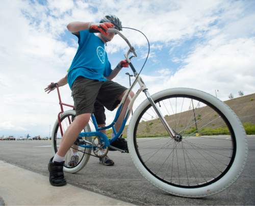 Steve Griffin  |  The Salt Lake Tribune


Peter Conder, 19, hopes on a bike as forty people with special needs, ranging from age 7 to 35,  learn to ride bicycles for the first time at a camp being conducted this week at Summit Academy High School in Bluffdale, Thursday, June 11, 2015.  The camp is called Ride to New Heights, and the local sponsor is the non-profit, United Angels Foundation, which supports families and parents of children with special needs. They've brought in the national non-profit, I Can Shine that provide  instructors and special bikes that help those with disabilities learn to balance and, ultimately, ride on their own.