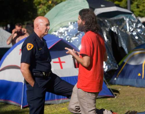 Al Hartmann  |  Tribune file photo
Salt Lake City Deputy Police Chief Mike Brown talks with Aharon-Ben-Or, right, one of the original organizers of the  Occupy Wall Street-Salt Lake protest in Pioneer Park in 2011.