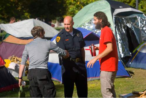 Al Hartmann  |  Tribune file photo
Salt Lake City Deputy Police Chief Mike Brown, center, shakes hands with one of the the Occupy Wall Street-Salt Lake protesters as Aharon-Ben-Or, one of the original organizers, looks on in 2011.