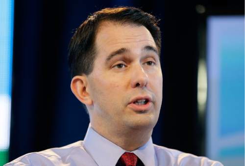 FILE - In this March 7, 2015, file photo, Wisconsin Gov. Scott Walker speaks during the Iowa Agriculture Summit in Des Moines, Iowa. Pegging him as rising opponent in the Republican race for president, rivals of Walker have identified his changing positions on several issues as a potent line of criticism. (AP Photo/Charlie Neibergall, File)