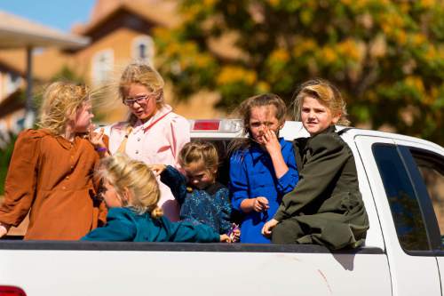 Trent Nelson  |  The Salt Lake Tribune
Young girls ride in the back of a truck in Hildale, Thursday September 25, 2014.