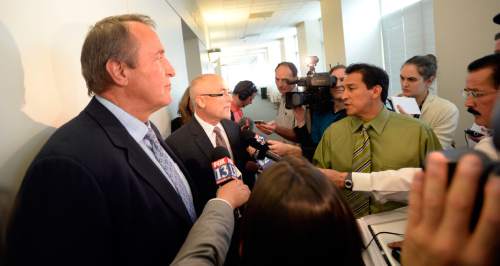 Al Hartmann |  The Salt Lake Tribune
Former Utah Attorney General Mark Shurtleff, left, stands and remains silent as his attorney Richard Van Wagonner talks to the media outside Judge Randall Skanchy's courtroom in Salt Lake City Monday June 15 after a preliminary hearing.
