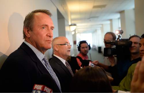 Al Hartmann |  The Salt Lake Tribune
Former Utah Attorney General Mark Shurtleff, left, stands and remains silent as his attorney Richard Van Wagonner talks to the media outside Judge Randall Skanchy's courtroom in Salt Lake City Monday June 15 after a preliminary hearing.