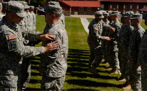 Trent Nelson  |  The Salt Lake Tribune
Fifty-three Utah Guardmembers are realigned to the 101st Airborne Division (Air Assault) in an "Old Abe" patch ceremony at Camp Williams in Bluffdale, Friday June 19, 2015.