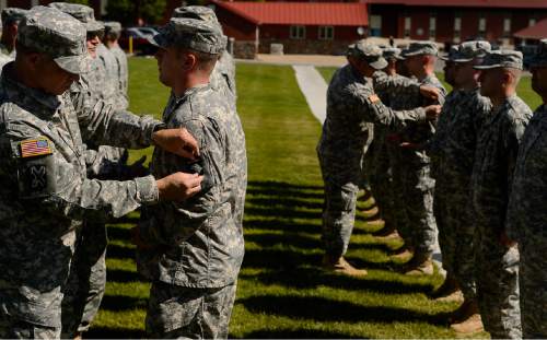 Trent Nelson  |  The Salt Lake Tribune
Fifty-three Utah Guardmembers are realigned to the 101st Airborne Division (Air Assault) in an "Old Abe" patch ceremony at Camp Williams in Bluffdale, Friday June 19, 2015.