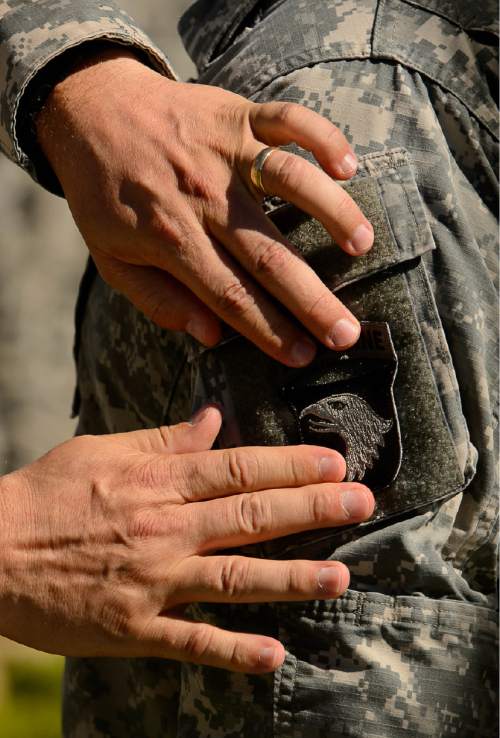 Trent Nelson  |  The Salt Lake Tribune
Fifty-three Utah Guardmembers are realigned to the 101st Airborne Division (Air Assault) in an "Old Abe" patch ceremony at Camp Williams in Bluffdale, Friday June 19, 2015.