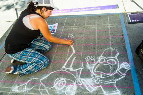 Chris Detrick  |  The Salt Lake Tribune
Marisa Green, of South Jordan, uses chalk to draw a scene from In & Outduring the 13th Annual Utah Foster Care Chalk Art Festival at The Gateway Friday June 19, 2015.  The festival draws more than 100 artists creating art at The Gateway to increase attention on how people can help change the lives of the 2,700 Utah children in foster care. The festival's artwork will be on display through Sunday.