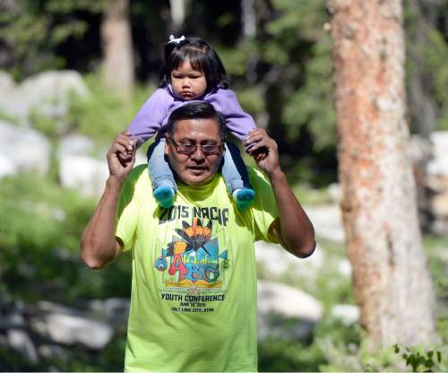 Al Hartmann |  The Salt Lake Tribune
Andrew Tso carries his granddaughter Macy Little on a nature walk at the Native American Church of North America's Youth Conference, part of its national conference at Redman Campground in Little Cottonwood Canyon Thursday June 18. The conference is expected to have 400 Native American children and their families attend the conference, which includes members from around the country and Canada.