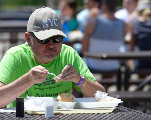 Leah Hogsten  |  The Salt Lake Tribune
YCC volunteer Richard Berrett tries a plate a  barbecue from one of the 23 teams from 6 states competing at the Real Men Can Cook event.  The 24th year of Real Men Can Cook, a fundraiser for the Your Community Connection Family Crisis Center in Ogden, Saturday, June 20, 2015, at Ogden Pioneer Stadium.