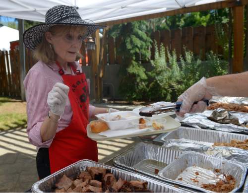 Leah Hogsten  |  The Salt Lake Tribune
YCC board member Jeannie Hall is served a healthy portion of  barbecue during the Real Men Can Cook event. The 24th year of Real Men Can Cook, a fundraiser for the Your Community Connection Family Crisis Center in Ogden, Saturday, June 20, 2015, at Ogden Pioneer Stadium.