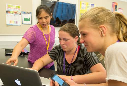 Rick Egan  |  The Salt Lake Tribune

Instructor Helen Hu (left) helps Jocelyn Frasier and Jade Moffat design an aplication for their cellphones at the four-day AWE+SUM Summer Girls Camp where eighth-grade girls participate in science and math and hands-on workshops at Westminster, Friday, June 19, 2015.