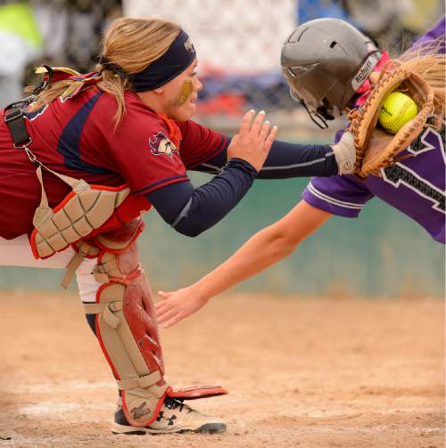 Trent Nelson  |  The Salt Lake Tribune
Herriman's Ashlyn Visser (55) tags out Lehi's Sydney White at home, as Herriman faces Lehi in the 5A high school softball championship game, in West Valley City, Friday May 22, 2015.
