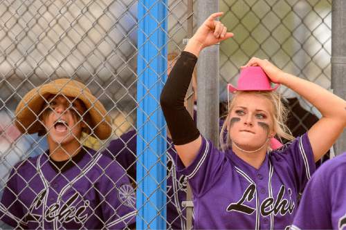 Trent Nelson  |  The Salt Lake Tribune
Lehi pitcher Sydney White, right, cheers on her team from the dugout during a 5A softball tournament second-round game between defending champion Lehi and No. 1 seed Taylorsville, Thursday May 14, 2015. At left is Bailey Tahbo.