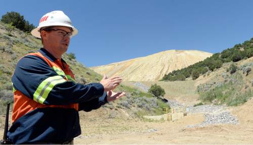 Al Hartmann |  The Salt Lake Tribune
Zeb Kenyon, senior environmental advisor for Rio Tinto, points out the newly constructed waste dump and cut-off wall that stabilizes the bottom of the tailings pile and deals with runoff from large rain events.