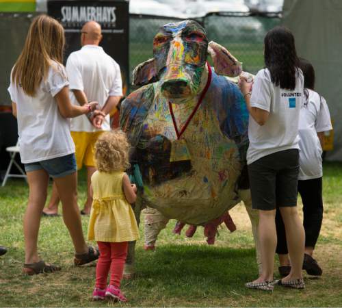 Steve Griffin  |  Tribune file photo

Children paint a giant cow during the 2014 Arts Festival in Salt Lake City. This year's festival is open daily through Sunday at Library Square.