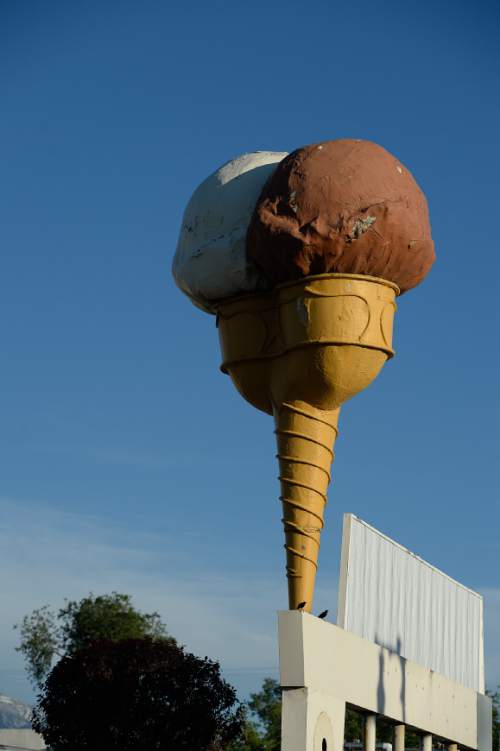 Francisco Kjolseth  |  The Salt Lake Tribune

The Snelgrove ice cream cone sits atop the sign that formerly marked the locally-owned ice cream shop on 2100 South. The original colors of the cone were brown and pinkóchococlate strawberry. Here the cone sits atop the now Dreyer ice cream facility, who say they plan to refurbish the cone and get it spinning again.