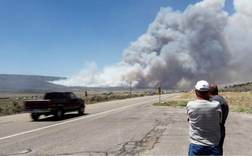 Al Hartmann  |  The Salt Lake Tribune  

Folks watch smoke plume from the Wood Hollow fire as it reaches U.S Highway 89 north of Indianola Wednesday June 27, 2012 at about 2:15. The fire was reinvigorated from high winds and the highway closed a few minutes later.