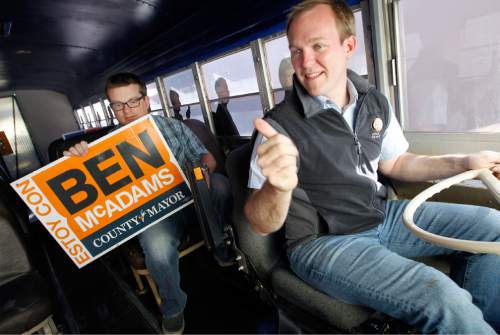 Al Hartmann  |  The Salt Lake Tribune
Newly elected Salt Lake County Mayor Ben McAdams, right, drives his orange campaign bus off the parking lot at his campaign headquarters as he begins to shut down his Salt Lake City office with  campaign manager, Justin Miller Wednesday November 7.