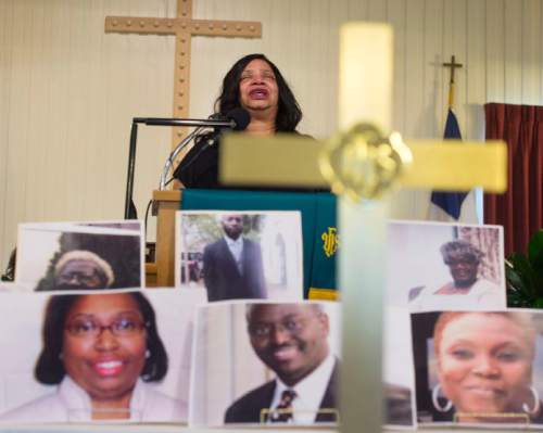 Steve Griffin  |  The Salt Lake Tribune
Rev. Michelle Dockery-Boyer weeps as she prays for the victims in the shootings in Charleston, South Carolina as their photos are displayed during prayer vigil at the Embry Chapel African Methodist Episcopal Church in Ogden on Friday. Each victim was remembered by nine interfaith religious leaders during the service.