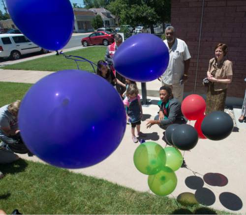 Steve Griffin  |  The Salt Lake Tribune


Rev. Brandee Jasmine Mimitzaraiem of the Embry Chapel African Methodist Episcopal Church helps children release balloons in remembrance of the victims in the shootings in Charleston, South Carolina following prayer vigil at the Ogden, Utah church Friday, June 19, 2015. Each victim was remembered by nine interfaith religious leaders during the service.