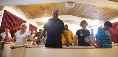 Steve Griffin  |  The Salt Lake Tribune


People hold hands in unity as they pray for the victims in the shootings in Charleston, South Carolina at the Embry Chapel African Methodist Episcopal Church in Ogden, Utah Friday, June 19, 2015. Each victim was remembered by nine interfaith religious leaders during the service.
