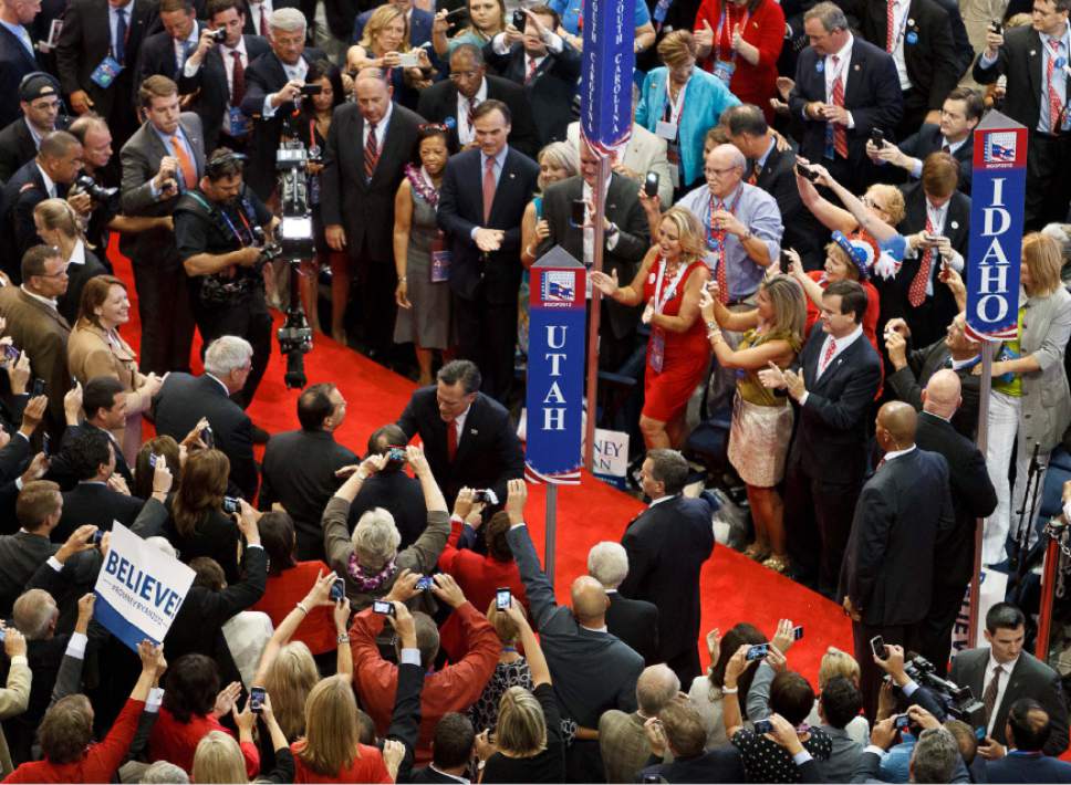 Trent Nelson  |  The Salt Lake Tribune
Mitt Romney shakes hands as he makes his entrance at the Republican National Convention in Tampa, Florida, Thursday, August 30, 2012.