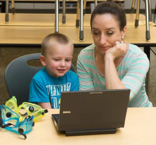 Rick Egan  |  The Salt Lake Tribune

Centennial Junior High school teacher, Angela Stewart takes a break to play a computer game with her 3-year-old son Kimball, as she organizes her classroom in Kaysville, Thursday, June 11, 2015.