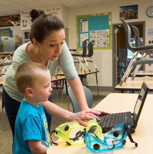 Rick Egan  |  The Salt Lake Tribune

Centennial Junior High school teacher, Angela Stewart takes a break to play a computer game with her 3-year-old son Kimball, as she organizes her classroom in Kaysville, Thursday, June 11, 2015.