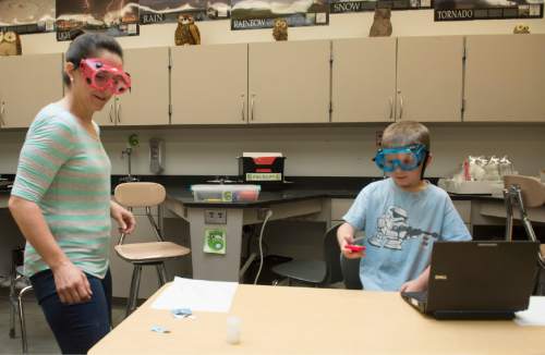Rick Egan  |  The Salt Lake Tribune

School teacher, Angela Stewart takes a break from organizing her classroom to do a science experiment with her 7-year-old son Davis, at Centennial Junior High School, in Kaysville, Thursday, June 11, 2015.
