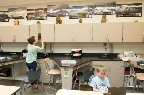 Rick Egan  |  The Salt Lake Tribune

Davis Stewart, 7 , plays a computer game as his mom Angela Stewart organizes her classroom at Centennial Junior High School, in Kaysville, Thursday, June 11, 2015.