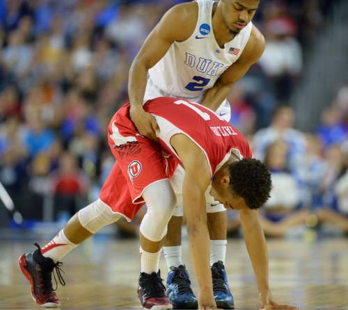 Steve Griffin  |  The Salt Lake Tribune

Duke Blue Devils guard Quinn Cook (2) helps up Utah Utes guard Brandon Taylor (11) after Taylor crashed to the court during first half action in the University of Utah versus Duke University Sweet 16 game in the 2015 NCAA Men's Basketball Championship Regional Semifinal game at NRG Stadium in Houston, Friday, March 27, 2015.