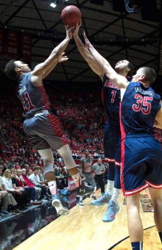 Rick Egan  |  The Salt Lake Tribune

Utah Utes guard Isaiah Wright (1) has his 3-point-shot blocked by Arizona Wildcats guard Gabe York (1) in the final minutes of the game, in Pac-12 basketball action in the Huntsman Center, Saturday, February 28, 2015.