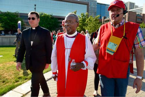 Scott Sommerdorf   |  The Salt Lake Tribune
Bishop Michael Curry of North Carolina, center, who was elected at the 27th Presiding Bishop of the Episcopal Church is escorted back into the Salt Palace after marching to protest gun in Salt Lake City, Sunday, June 28, 2015.