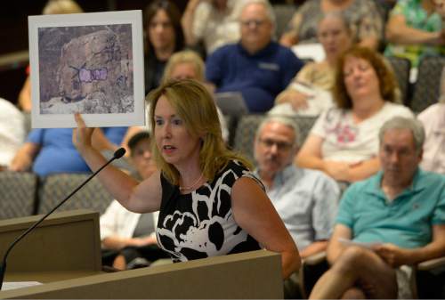 Leah Hogsten  |  The Salt Lake Tribune
Jemina Keller shows the council pictures of vandalism, graffiti and other problems Millcreek Canyon faces, especially the Grandeur Peak trailhead and open space in Millcreek. In parting, Keller gave the council four words, "Big Cottonwood Canyon Tavici". The Salt Lake County Council listens to public comment on the boundaries of the townships and unincorporated islands involved in this November's Community Preservation election, Tuesday, June 30, 2015.