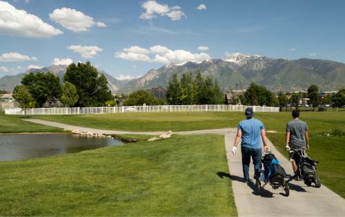Rick Egan  |  The Salt Lake Tribune

David Nielson and Bronson Schroeder head to the clubhouse after playing golf at Mulligans, Monday, June 1, 2015.
