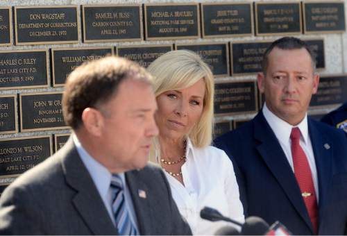 Al Hartmann |  The Salt Lake Tribune
Nannette Wride, widow of slain Utah County Sheriff Sgt. Cory Wride listens as Gov. Gary Herberts speaks at police memorial outside the Utah Capitol before signing HB 288, which provides death benefits for Utah peace
officers and firefighters killed in the line of duty.  Rep. Paul Ray, the bill's sponsor at right.