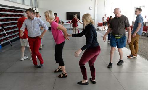 Francisco Kjolseth | The Salt Lake Tribune  
Janice Bosworth, center left, is partnered with Lennie Swenson during a movement class at the University of Utah for people living with Parkinson's Disease. In a collaboration between the Department of Physical Therapy and the Department of Modern Dance, Assistant Professor Juan Carlos Claudio and University of Utah alumna Lennie Swenson are using their training in dance, creative movement, and physical therapy to help people with Parkinson's maintain their motor skills.