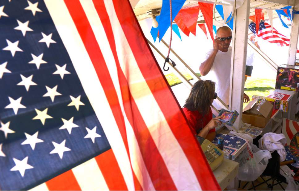 Leah Hogsten  |  The Salt Lake Tribune
l-r "She and her dad are like big kids," said Amanda Webster of her husband Ronald as the two bought  sparklers for their daughter Alia Jo, 6, and other small fireworks for the Fourth of July celebration. Fireworks went on sale Wednesday, July 1, 2015.