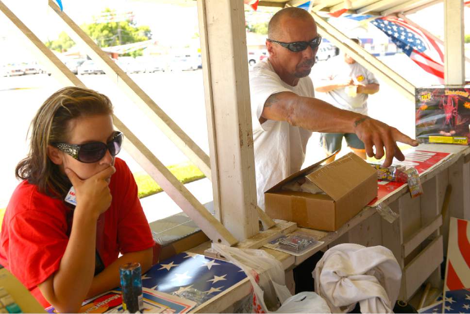 Leah Hogsten  |  The Salt Lake Tribune
l-r "She and her dad are like big kids," said Amanda Webster of her husband Ronald as the two bought  sparklers for their daughter Alia Jo, 6, and other small fireworks for the Fourth of July celebration. Fireworks went on sale Wednesday, July 1, 2015.