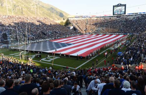 Steve Griffin  |  The Salt Lake Tribune
A giant American Flag is held by BYU Army and Air Force ROTC members as well as the BYU and Houston football players on Sept. 11, 2014, in honor of the anniversary of 9/11 before the start of the game between BYU and Houston and LaVell Edwards Stadium in Provo.
