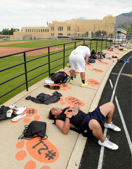 Al Hartmann |  The Salt Lake Tribune
Next season's Ogden High School football team players lie down in exhaustion after a summer conditioning workout Thursday June 11, 2015.  The team belongs in Class 4A purely by enrollment numbers, but the football program argued during recent UHSAA realignment meetings that, based on a historic lack of competitiveness, it should be dropped down a classification or two to allow the program to rebuild.
