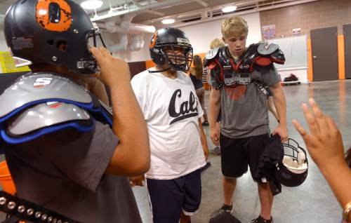 Leah Hogsten  |  The Salt Lake Tribune
Players are fitted with pads and a helmet after practice Wednesday, June 10, 2015. After last season's struggle, Ogden High School's  football program decided to play an independent schedule for the next two years.