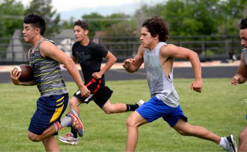 Al Hartmann |  The Salt Lake Tribune
Next season's Ogden High School football players run wind sprints during a summer conditioning workout Thursday June 11, 2015. The team belongs in Class 4A purely by enrollment numbers, but the football program argued during recent UHSAA realignment meetings that, based on a historic lack of competitiveness, it should be dropped down a classification or two to allow the program to rebuild.