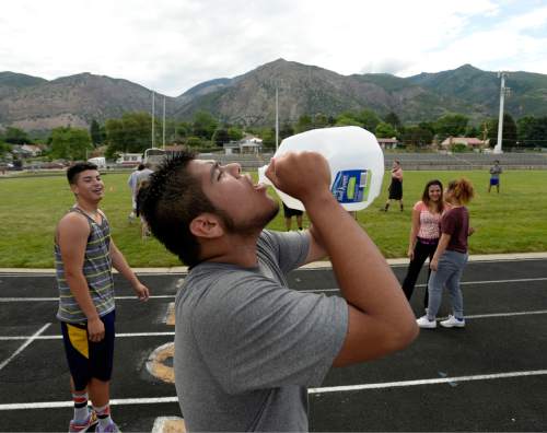 Al Hartmann |  The Salt Lake Tribune
Next season's Ogden High School football team players take a water break during a summer conditioning workout Thursday June 11, 2015. The team belongs in Class 4A purely by enrollment numbers, but the football program argued during recent UHSAA realignment meetings that, based on a historic lack of competitiveness, it should be dropped down a classification or two to allow the program to rebuild.