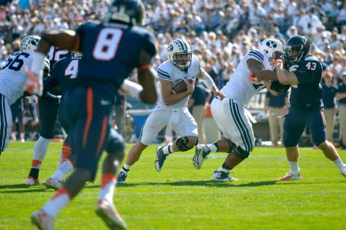 Chris Detrick  |  The Salt Lake Tribune
Brigham Young Cougars quarterback Taysom Hill (4) runs the ball during the second half of the game at LaVell Edwards Stadium Saturday September 20, 2014.  BYU won the game 41-33.