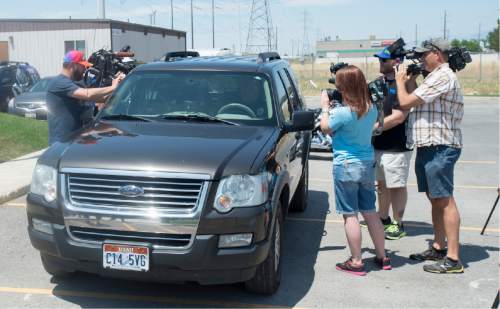 Rick Egan  |  The Salt Lake Tribune

Members of the media films West Valley Police Officer, Dana Pugmire, as he sits in his car for 15 minutes in the heat of the day, during a press conference to illustrate the dangers of leaving children and pets in hot cars, Thursday, July 2, 2015.