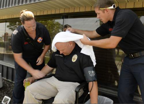 Rick Egan  |  The Salt Lake Tribune

West Valley Paramedics, try to cool down Police Officer, Dana Pugmire's after he sat in his car for 15 minutes in the heat of the day, during a press conference to illustrate the dangers of leaving children and pets in hot cars, Thursday, July 2, 2015.