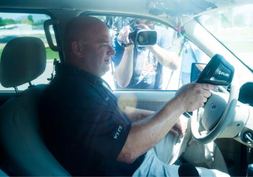 Rick Egan  |  The Salt Lake Tribune

West Valley Police Officer, Dana Pugmire, measures the temperature of the dashboard, as he sits in his car for 15 minutes in the heat of the day, during a press conference to illustrate the dangers of leaving children and pets in hot cars, Thursday, July 2, 2015.