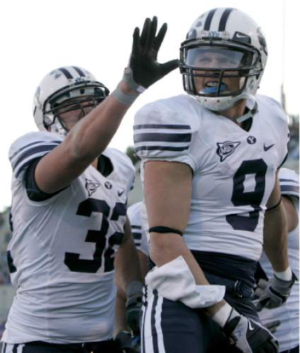 BYU tight end Dennis Pitta (32) congratulates teammate Austin Collie (9) after Collie hauled in a 6-yard pass for a touchdown in the third quarter of BYU's 38-24 victory in an NCAA college football game at Air Force Academy, Colo., Saturday, Nov. 15, 2008. Collie led the Cougars with 130 receiving yards including two touchdowns. (AP Photo/Justin Edmonds)